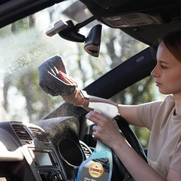 Women using a glass cleaner interior