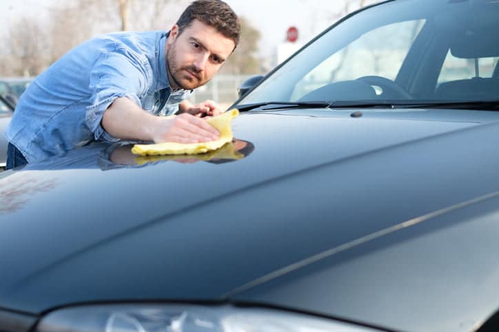 Man taking care and cleaning his new car