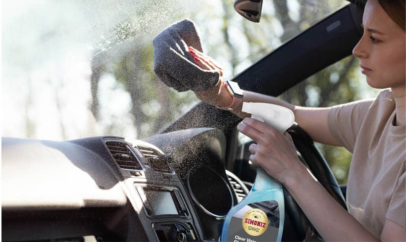 Women using a glass cleaner interior