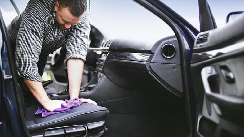 Man cleaning inside car