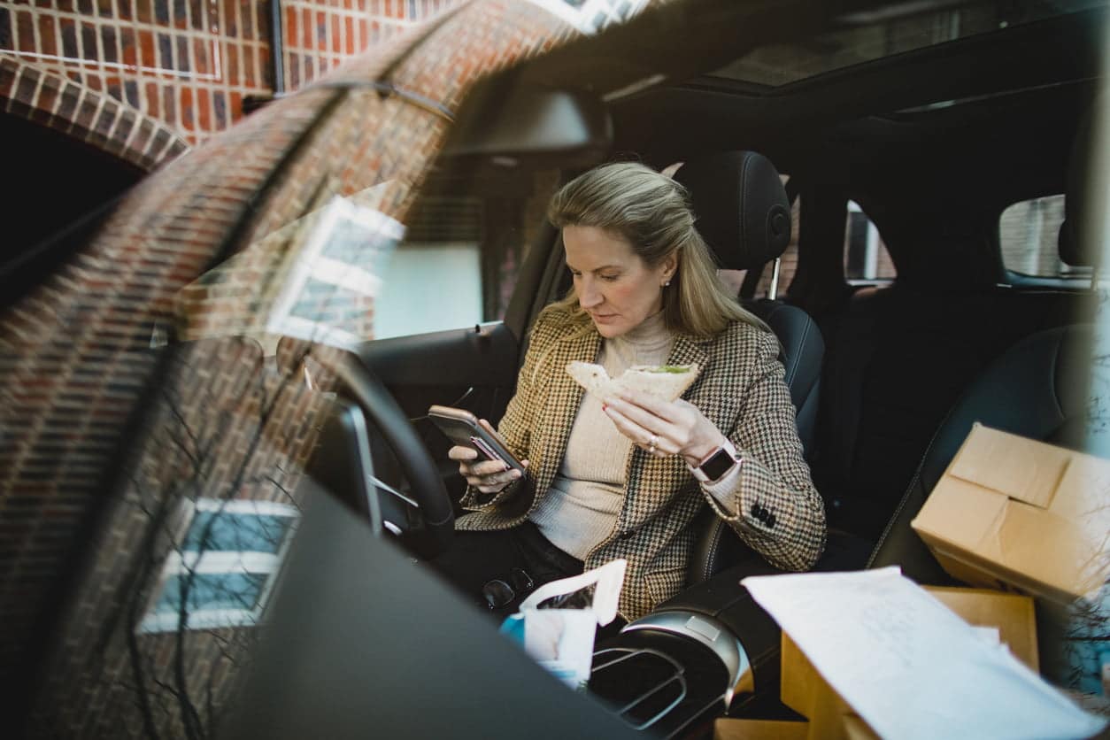 image of woman eating in car