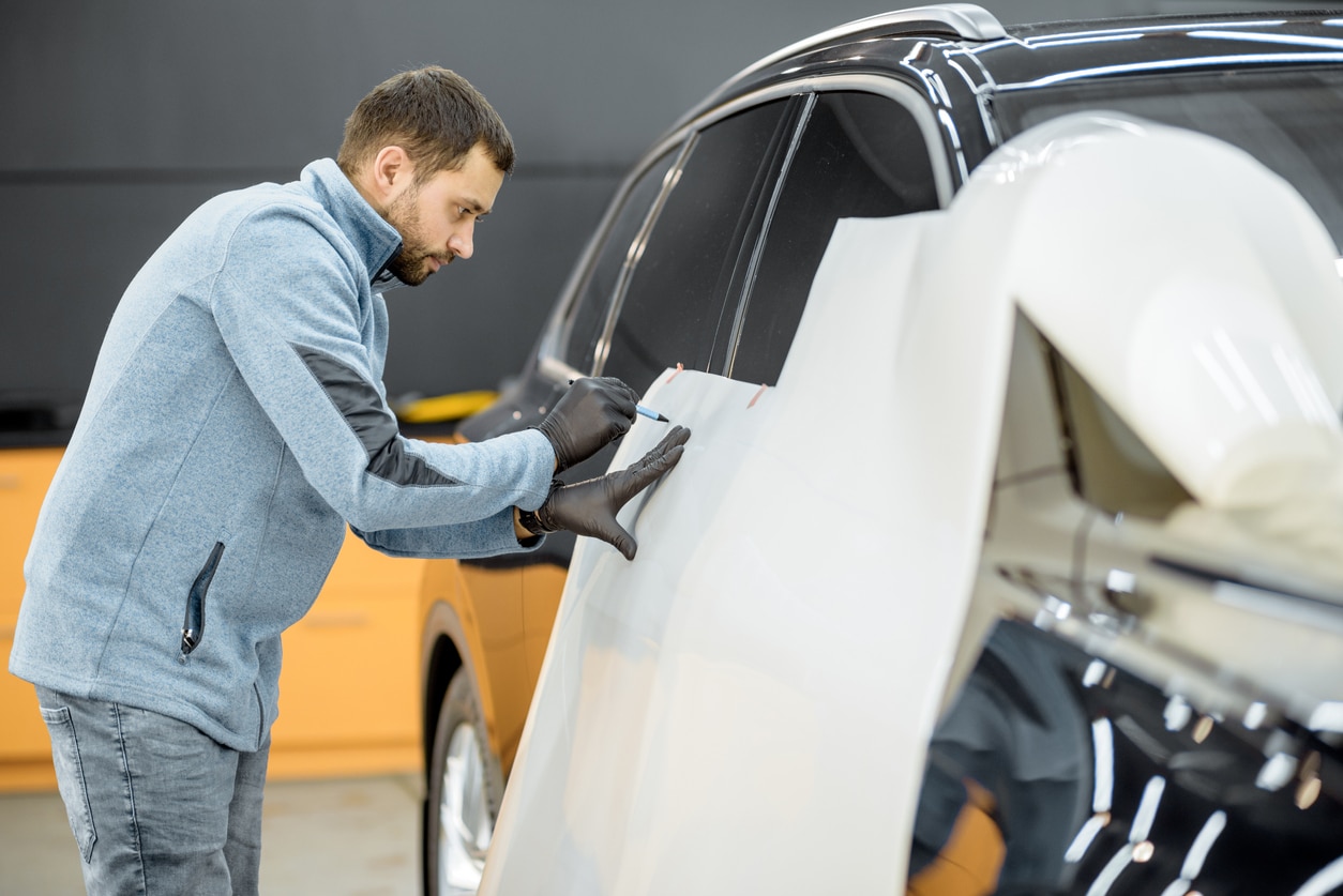 man wrapping car body