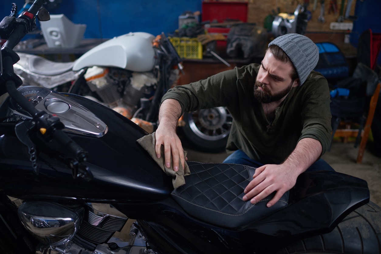 man cleaning his motorcycle