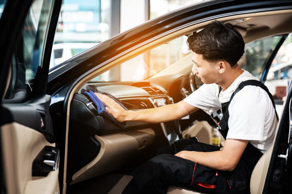 man cleaning car interior