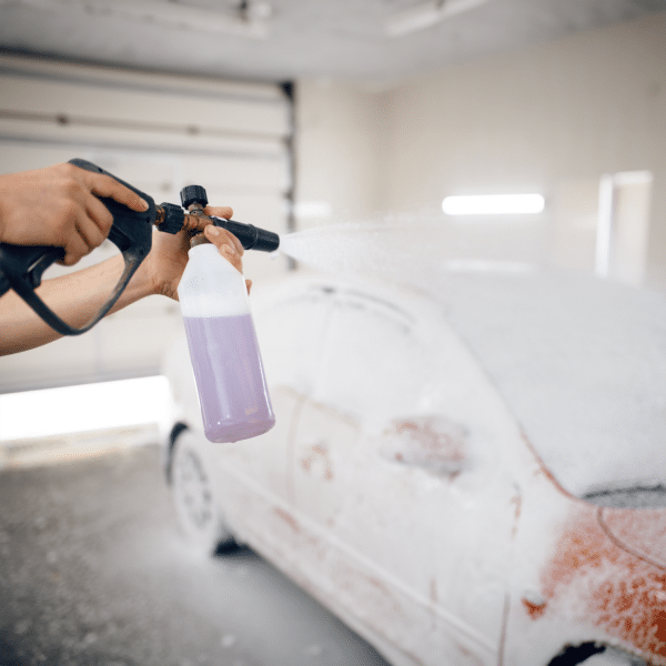 Car being sprayed and covered with Simoniz Snow Foam