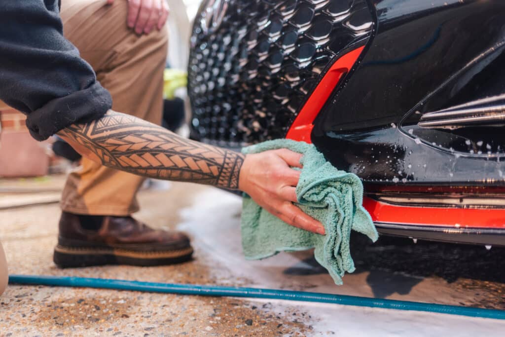 Auto Detailing - Man Washing Car with Micorfiber Towel - Close Up